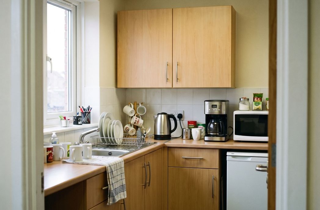 a small but well-maintained office kitchenette in a modern workplace